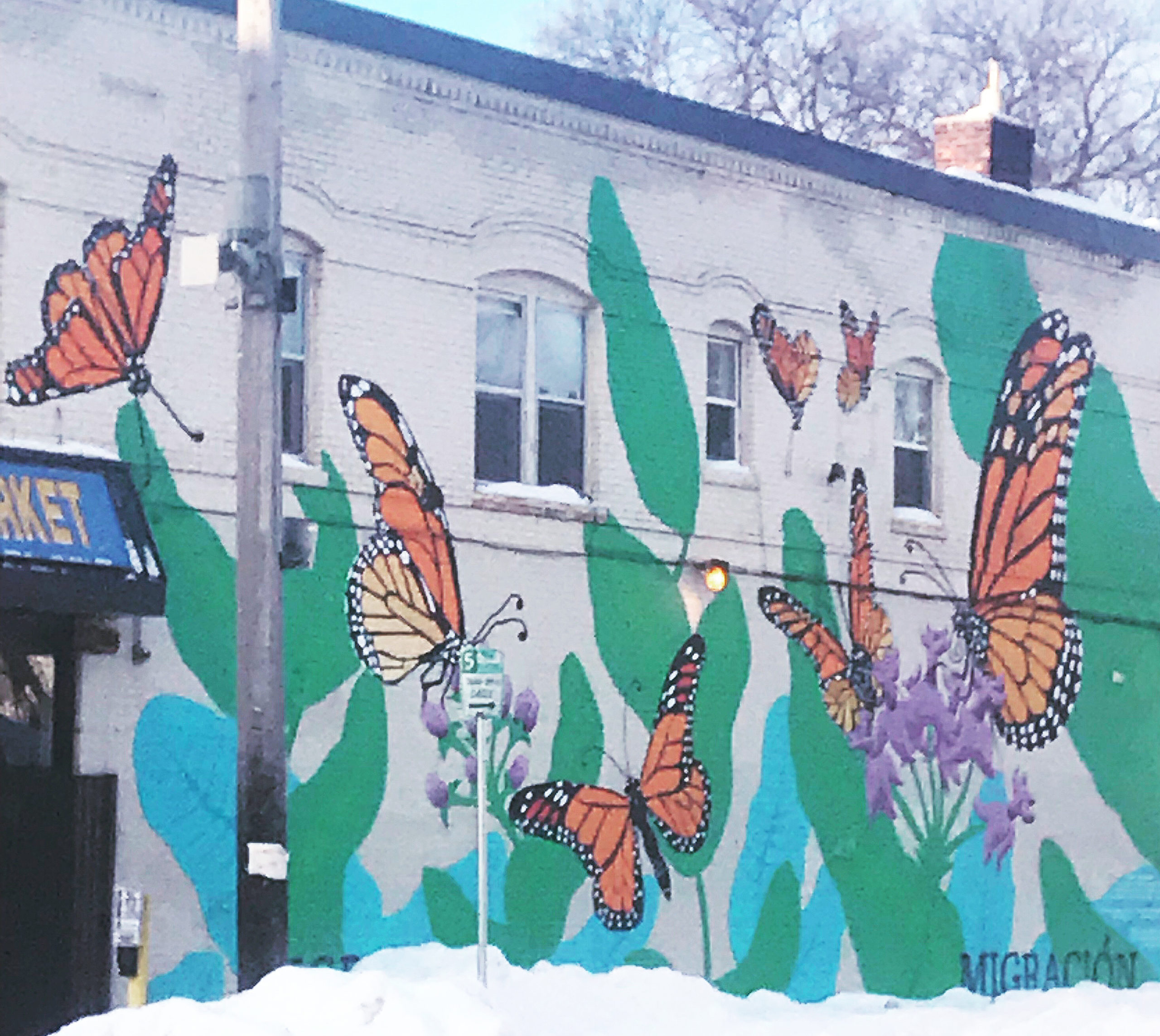 Colorful butterfly mural over brick wall